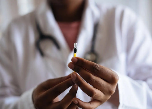 doctor holding vaccine shot